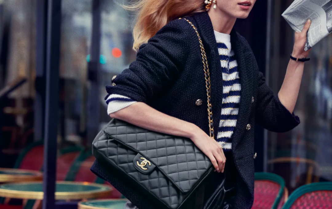 A close-up of the classic Chanel flap bag, showcasing its quilted leather texture, refined stitching, and the iconic flap closure design.