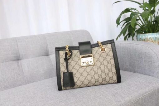 GUCCI Padlock Small GG Shoulder Bag. Authentic Quality Bag with literature, gift box, dust bag and authenticity card. A structured shoulder bag in GG Supreme canvas with a strap that secures with a key lock closure pulled straight from the archives. The key is placed in a detachable leather key case.