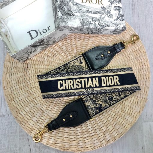 DIOR Christian Dior Shoulder Strap. Original Quality Strap including gift box, care book, dust bag, authenticity card. The 'Christian Dior' signature is featured at the center of the slender shape, framed by black calfskin on either side. Two antique gold-finish metal snap hooks attach the strap to the bag of choice. The strap may be worn over the shoulder or crossbody for a highly personalized style.