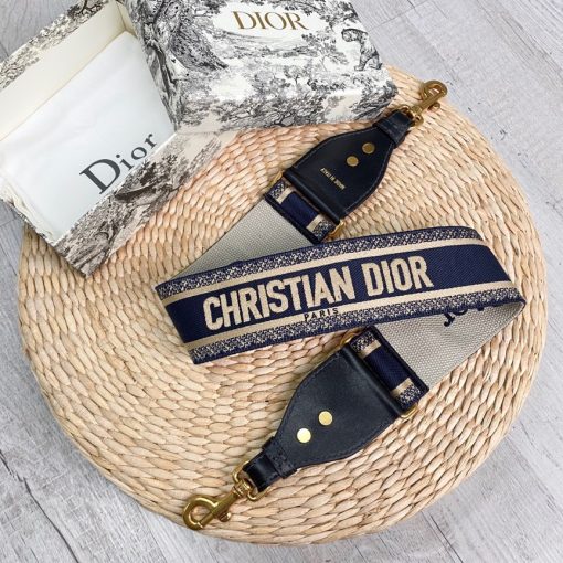 DIOR Christian Dior Shoulder Strap. Original Quality Strap including gift box, care book, dust bag, authenticity card. The 'Christian Dior' signature is featured at the center of the slender shape, framed by black calfskin on either side. Two antique gold-finish metal snap hooks attach the strap to the bag of choice. The strap may be worn over the shoulder or crossbody for a highly personalized style.