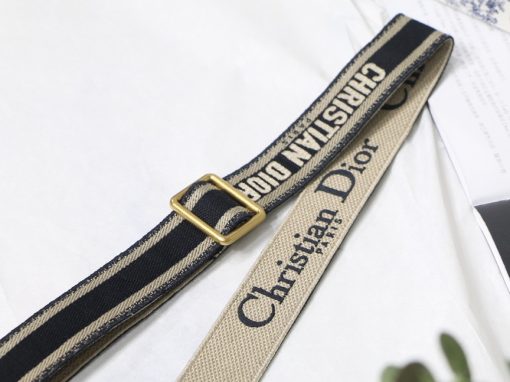 DIOR Christian Dior Shoulder Strap. Original Quality Strap including gift box, care book, dust bag, authenticity card. The 'Christian Dior' signature is featured at the center of the slender shape, framed by black calfskin on either side. Two antique gold-finish metal snap hooks attach the strap to the bag of choice. The strap may be worn over the shoulder or crossbody for a highly personalized style.