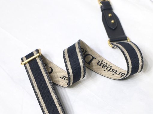 DIOR Christian Dior Shoulder Strap. Original Quality Strap including gift box, care book, dust bag, authenticity card. The 'Christian Dior' signature is featured at the center of the slender shape, framed by black calfskin on either side. Two antique gold-finish metal snap hooks attach the strap to the bag of choice. The strap may be worn over the shoulder or crossbody for a highly personalized style.