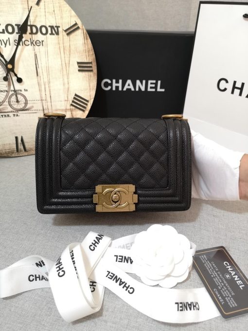 CHANEL Small Boy Handbag. Original Quality Bag including gift box, care book, dust bag, authenticity card. Even though the Boy was only introduced in 2011, the style has quickly achieved the status of an icon. Designed by Karl Lagerfeld and named after Boy Capel, the now legendary love of Coco Chanel’s life, the bag encapsulates masculine chic conveyed through rigid structure, boxy shape and sharp corners. This CHANEL Small Handbag is instantly recognizable for its simple, boxy silhouette and sharp corners, embellished only with a contrasting, bold-looking link chain strap which is the main feature of the bag. This most popular variations of the Chanel Boy are available in either caviar or lambskin. There are no external pockets and the sole adornment is the quilted fascia.