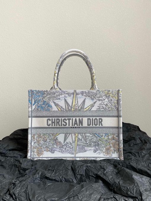 DIOR Book Tote. Original Quality Bag including gift box, care book, dust bag, authenticity card. This Book Tote is an original style introduced by Creative Director Maria Grazia Chiuri. This has become a staple of the Dior aesthetic. Ideally designed to carry all your daily essentials, the small shape is fully embroidered and the 'Christian Dior' signature on the front. This carryall is a perfect example of the Dior savoir-faire and also may be coordinated with a pouch or other small leather goods for a complete look.