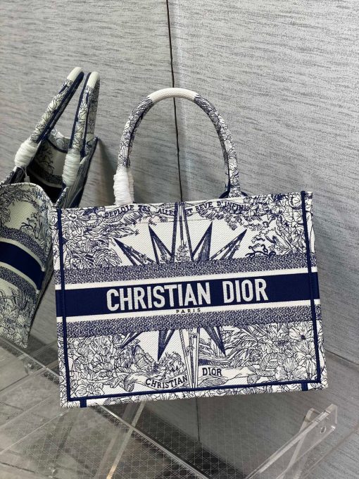 DIOR Book Tote. Original Quality Bag including gift box, care book, dust bag, authenticity card. This Book Tote is an original style introduced by Creative Director Maria Grazia Chiuri. This has become a staple of the Dior aesthetic. Ideally designed to carry all your daily essentials, the small shape is fully embroidered and the 'Christian Dior' signature on the front. This carryall is a perfect example of the Dior savoir-faire and also may be coordinated with a pouch or other small leather goods for a complete look.