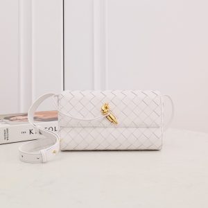 BOTTEGA VENETA Mini Andiamo: Timeless Craftsmanship, Effortless Versatility. Discover Bottega Veneta’s latest addition to the 'Andiamo' collection by Creative Director Matthieu Blazy. This exquisite bag is meticulously hand-woven from supple leather strips, showcasing the brand's iconic intrecciato technique. The design is elevated by a luxurious gilded 'Knot' detail at the front, adding a touch of elegance. Inside, you’ll find a compact interior with a zipped pocket, perfect for organizing your essentials. For ultimate versatility, tuck in the shoulder strap and transform this piece into a sophisticated clutch. With the Andiamo bag, style meets function in timeless Bottega Veneta fashion.
