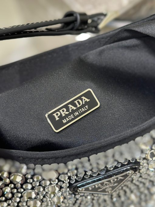 PRADA Cleo Satin Bag With Crystals. Original Quality Bag including gift box, care book, dust bag, authenticity card. Feminine, elegant and modern, the Prada Cleo bag is made of satin and embellished with luminous crystals of different sizes that give the bag refined charm. The sinuous shape that recalls archive styles makes the accessory iconic.