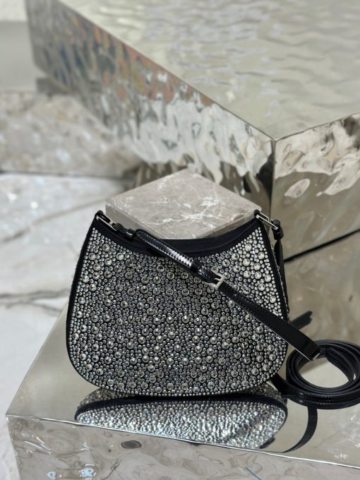 PRADA Cleo Satin Bag With Crystals. Original Quality Bag including gift box, care book, dust bag, authenticity card. Feminine, elegant and modern, the Prada Cleo bag is made of satin and embellished with luminous crystals of different sizes that give the bag refined charm. The sinuous shape that recalls archive styles makes the accessory iconic.