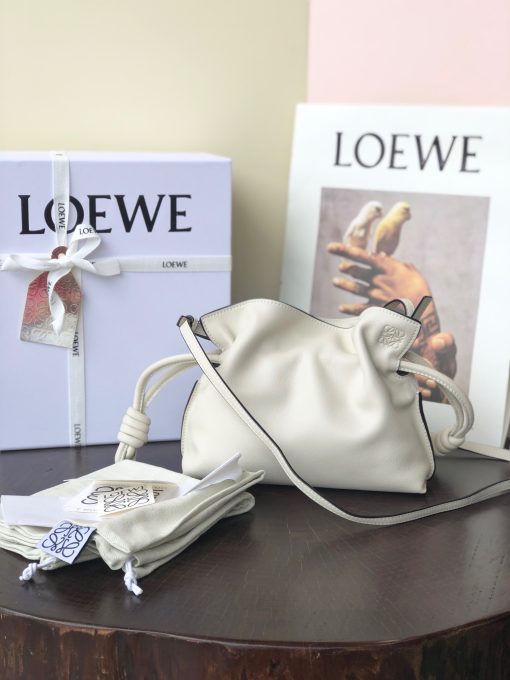 LOEWE Mini Flamenco Clutch. Original Quality Bag including gift box, care book, dust bag, authenticity card. Launched in the 1970s, the Flamenco Clutch cinches closed using drawstring pulls finished in signature coiled knots. This mini version is crafted in nappa calfskin. The Flamenco mini can hold for example a small vertical wallet, most mobile phones (up to 6.1 inches) and sunglasses case. Suitable for shoulder, crossbody or hand carry.