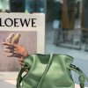 LOEWE Mini Flamenco Clutch. Original Quality Bag including gift box, care book, dust bag, authenticity card. Launched in the 1970s, the Flamenco Clutch cinches closed using drawstring pulls finished in signature coiled knots. This mini version is crafted in nappa calfskin. The Flamenco mini can hold for example a small vertical wallet, most mobile phones (up to 6.1 inches) and sunglasses case. Suitable for shoulder, crossbody or hand carry.