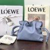 LOEWE Mini Flamenco Clutch. Original Quality Bag including gift box, care book, dust bag, authenticity card. Launched in the 1970s, the Flamenco Clutch cinches closed using drawstring pulls finished in signature coiled knots. This mini version is crafted in nappa calfskin. The Flamenco mini can hold for example a small vertical wallet, most mobile phones (up to 6.1 inches) and sunglasses case. Suitable for shoulder, crossbody or hand carry.