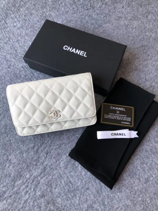 CHANEL Classic Wallet on Chain. Authentic Quality Wallet, including gift box, literature, dust bag, authenticity card. Classic and elegant, a Chanel bag is a fashion statement to your outfit, as seen in this caviar leather flap wallet on chain. Featuring a diamond quilted finish, metal-tone hardware, a foldover top, an internal zipped pocket, an internal slip pocket, an internal logo stamp, a back slip pocket, tortoiseshell details, and a CC turn-lock fastening.