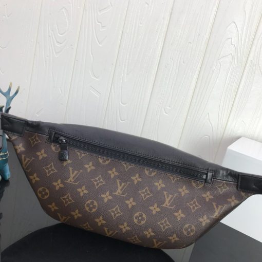 LOUIS VUITTON Discovery Bum Bag. Combining casual sophistication with contemporary practicality, the Discovery Bumbag is the perfect city companion. It is fashioned from Monogram Eclipse canvas/Monogram Shadow leather and adorned with zipped pockets on the front and back for easy access. With its adjustable belt and body-friendly design, it can be worn stylishly slung across the chest, draped over the shoulder or simply strapped around the waist.