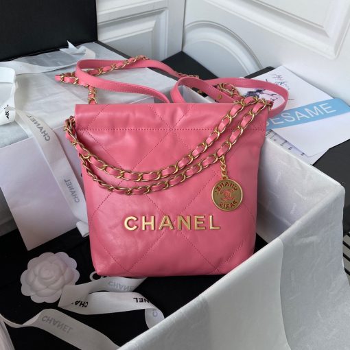 CHANEL 22 Mini Handbag. Original Quality Bag including gift box, care book, dust bag, authenticity card. The Chanel 22 Handbag, has a shape, versatility, and buzz all its own, bringing a casual, even bohemian flare to the always-dressed fashion house. This is crafted of diamond-stitched calfskin leather. The bag features leather threaded silver chain shoulder straps and a matching Chanel logo on the front. The open top with magnetic closure leads to a black fabric interior with a zipper pocket and a removable pouch.