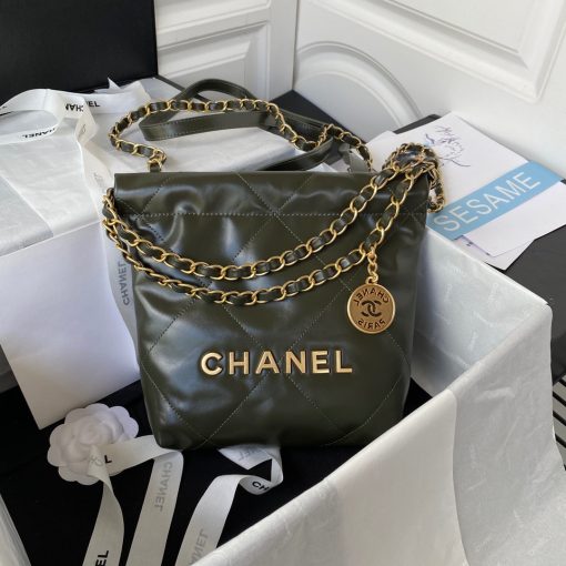 CHANEL 22 Mini Handbag. Original Quality Bag including gift box, care book, dust bag, authenticity card. The Chanel 22 Handbag, has a shape, versatility, and buzz all its own, bringing a casual, even bohemian flare to the always-dressed fashion house. This is crafted of diamond-stitched calfskin leather. The bag features leather threaded silver chain shoulder straps and a matching Chanel logo on the front. The open top with magnetic closure leads to a black fabric interior with a zipper pocket and a removable pouch.