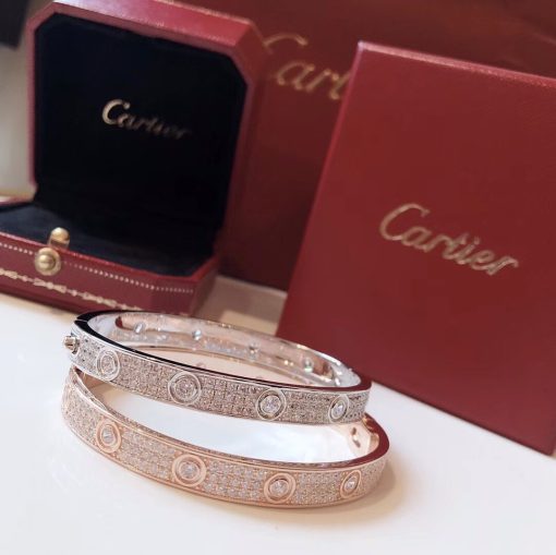 CARTIER Paved Love Bracelet. Original Quality Bracelet including gift box, care book, dust bag, authenticity card. A child of 1970s New York, the LOVE collection remains today an iconic symbol of love that transgresses convention. The screw motifs, ideal oval shape and undeniable elegance establish the piece as a timeless tribute to passionate romance. Studded with zirconia stones, yellow gold, white gold or rose gold: how far would you go for love! Cartier continues to write the story of the Love bracelet. Same design, same oval shape, same story: a timeless – creation which is fastened using a screwdriver. The closure is designed with a functional screw on one side of the bracelet and a hinge on the other. To determine the size of your Love bracelet, measure your wrist, adding one centimeter to your size for a tighter fit, or two centimeters for a looser fit.