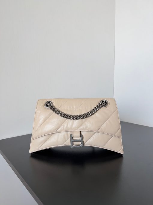 BALENCIAGA Crush Small Chain Bag. Original Quality Bag including gift box, care book, dust bag, authenticity card. Crush on this metallic Crush Chain Bag. This is a new iteration on their celebrated curvilinear design, complete with tonal B logo hardware and shoulder and crossbody chain. Crafted in a contemporary crushed quilted calfskin.