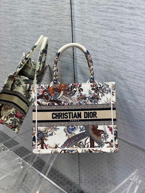 DIOR Small Book Tote. Original Quality Bag including gift box, care book, dust bag, authenticity card. This DIOR Tote is an original creation introduced by Dior's Creative Director, Maria Grazia Chiuri, and has become a staple of the Dior aesthetic. Designed to hold all the daily essentials, it is fully embroidered. Adorned with a Christian Dior Paris signature on the front, the small tote exemplifies the House's signature savoir-faire and may be carried by hand.