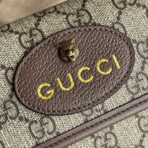 GUCCI Neo Vintage GG Supreme belt bag. The belt bag in GG Supreme has a retro-influenced design. Trimmed with leather, the style is meant to be worn around the waist, securing with a Web strap and buckle closure. Beige/ebony GG Supreme canvas, a material with low environmental impact, with brown leather trims. Green and red Web. Oval Gucci leather tag with a feline head. Adjustable nylon Web belt with plastic buckle closure.