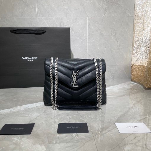 SAINT LAURENT Small Loulou Matelassé Bag. If asked to describe the design of the SAINT LAURENT Small Loulou Matelassé Bag in a few words, we’d say that it is a feminine bag with a slight rock and roll feel to it. One of the most noticeable things about the look of the LouLou is the padded quilted leather, a feature which gives the bag more volume. The leather padded chain handles and the metal interlocking YSL initials on the front flap, make it a bold, yet still classic, luxury handbag. Versatility is another strong point of the YSL LouLou bag, and it can definitely be dressed up or down for any occasion. The chain strap is moveable, which means it can also be worn as a crossbody bag.