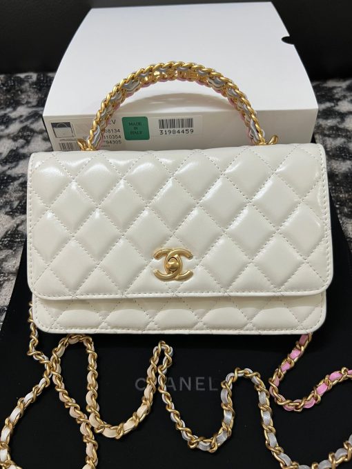 CHANEL Wallet On Chain With Signature Handle. Original Quality Bag including gift box, care book, dust bag, authenticity card. This is a seasonal bag from the Chanel Spring Summer 2022 SLG Collection. The design itself is so special about it. This bag is made with calfskin in diamond quilting. Then the center is refined with a vintage golden CC logo. The signature handle on the top to joints the woven leather strap. This bag comes with a back-pocket and a main compartment with card holders and chain pocket.