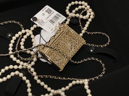 CHANEL Long Necklace. This CHANEL Long Necklace- Gold, Black & Pearly White is part of the Spring-Summer 2021 fashion collection. The artistry and craftsmanship of the House of CHANEL.