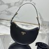 PRADA Leather Shoulder Bag.  High-End Quality Bag including gift box, care book, dust bag, authenticity card. This sleek leather bag expresses versatile, modernist allure. The accessory with a curvy silhouette is completed by the leather extension for versatile wear. With a nappa leather lining and metal hardware, the bag is accented with the iconic enameled metal triangle logo on the front.