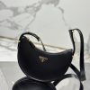 PRADA Leather Shoulder Bag.  High-End Quality Bag including gift box, care book, dust bag, authenticity card. This sleek leather bag expresses versatile, modernist allure. The accessory with a curvy silhouette is completed by the leather extension for versatile wear. With a nappa leather lining and metal hardware, the bag is accented with the iconic enameled metal triangle logo on the front.