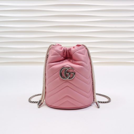 GUCCI GG Marmont Mini Bucket Bag. Original Quality Bag including gift box, literature, dust bag, authenticity card. The world of GG Marmont expands with the introduction of a mini bucket bag shape crafted from Matelassé leather in vibrant tones. Inspired by an archival design from the '70s, a hallmark era of the House, the Double G decorates the front of this accessory. Featuring a chain strap and drawstring closure the versatile shape can be worn as shoulder and as a crossbody bag.