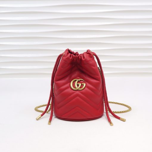 GUCCI GG Marmont Mini Bucket Bag. Original Quality Bag including gift box, literature, dust bag, authenticity card. The world of GG Marmont expands with the introduction of a mini bucket bag shape crafted from Matelassé leather in vibrant tones. Inspired by an archival design from the '70s, a hallmark era of the House, the Double G decorates the front of this accessory. Featuring a chain strap and drawstring closure the versatile shape can be worn as shoulder and as a crossbody bag.