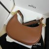 CELINE Medium Ava Strap Bag. High-End Quality Bag including gift box, care book, dust bag, authenticity card. Celine's Ava bag is a perfect example of the brand's signature style, with powerful understated elegance. Crafted from a variety of materials, including iconic leather and textiles with the stylish Celine logo plastering the surface, the bag is a classic with a hint of '80s-inspired blouson. Taking inspiration from the iconic Arc de Triomphe, the logo features two opposites-facing Cs and a patterned center. The minimalist aesthetic of the new logo and colors perfectly encapsulates the essence of the brand. The semi-moon silhouette and adjustable shoulder straps allows the bag to be styled any number of ways, making it perfect for someone who carries minimal items on a daily basis without needing a crossbody strap. With enough room for the essentials, the Celine Ava bag is an ultimate cool-girl essential.
