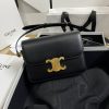 CELINE Teen Triomphe. High-End Quality Bag including gift box, care book, dust bag, authenticity card. In 2018, Hedi Slimane released the original Triomphe to much acclaim. Since then, the stylish purse has been spotted on the arms of celebrities and fashion insiders across the world. With its smooth leather exteriors and minimalistic hardware, the crossbody design reconciles fashion and function, featuring Celine's signature golden Triomphe logo fastener. It has attracted the attention of bag collectors and fashion historians alike for its sophisticated yet simple design. This classic piece has inspired a series of spinoffs, proving its timelessness and forever cementing the Triomphe as a fashion icon.