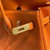 HERMÈS Birkin. Exquisite Craftsmanship and Timeless Elegance: Discover the Allure of the HERMES Birkin Bag Large Leather Top Handle. Designed with the actress Jane Birkin in mind, the Birkin bag is a contemporary development of the Kelly bag. Created based on Jane's suggestions, it was architected to be more significant to fit modern women's fast-paced life, with several minor yet outstanding adaptations, such as the elongated top handles. The French Birkin 30 bag is a classic touch of elegance to your look! The accessory features a trapeze body, a pebbled leather texture, a hanging key fob, gold-tone hardware, round top handles, a padlock fastening detail, a foldover top with twist-lock closure, a front center logo stamp, an internal zipped pocket, and purse feet.