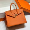 HERMÈS Birkin. Exquisite Craftsmanship and Timeless Elegance: Discover the Allure of the HERMES Birkin Bag Large Leather Top Handle. Designed with the actress Jane Birkin in mind, the Birkin bag is a contemporary development of the Kelly bag. Created based on Jane's suggestions, it was architected to be more significant to fit modern women's fast-paced life, with several minor yet outstanding adaptations, such as the elongated top handles. The French Birkin 30 bag is a classic touch of elegance to your look! The accessory features a trapeze body, a pebbled leather texture, a hanging key fob, gold-tone hardware, round top handles, a padlock fastening detail, a foldover top with twist-lock closure, a front center logo stamp, an internal zipped pocket, and purse feet.