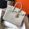 HERMÈS Birkin. Exquisite Craftsmanship and Timeless Elegance: Discover the Allure of the HERMES Birkin Bag Large Leather Top Handle. Designed with the actress Jane Birkin in mind, the Birkin bag is a contemporary development of the Kelly bag. Created based on Jane's suggestions, it was architected to be more significant to fit modern women's fast-paced life, with several minor yet outstanding adaptations, such as the elongated top handles. The French Birkin 30 bag is a classic touch of elegance to your look! The accessory features a trapeze body, a pebbled leather texture, a hanging key fob, gold-tone hardware, round top handles, a padlock fastening detail, a foldover top with twist-lock closure, a front center logo stamp, an internal zipped pocket, and purse feet.