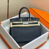 HERMÈS Birkin. Exquisite Craftsmanship and Timeless Elegance: Discover the Allure of the HERMES Birkin Bag Large Leather Top Handle. Designed with the actress Jane Birkin in mind, the Birkin bag is a contemporary development of the Kelly bag. Created based on Jane's suggestions, it was architected to be more significant to fit modern women's fast-paced life, with several minor yet outstanding adaptations, such as the elongated top handles. The French Birkin 30 bag is a classic touch of elegance to your look! The accessory features a trapeze body, a pebbled leather texture, a hanging key fob, gold-tone hardware, round top handles, a padlock fastening detail, a foldover top with twist-lock closure, a front center logo stamp, an internal zipped pocket, and purse feet.