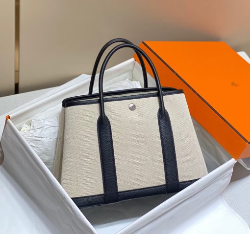 HERMÈS Garden Party: Style for Every Occasion. This Garden Party tote is the perfect blend of style and practicality. This chic and sporty bag is designed for every occasion, whether spending the day amongst the hustle and bustle of the city or enjoying a peaceful weekend in the countryside. Crafted with both leather and canvas, it's the perfect choice for whatever your destination. Not only is it spacious enough to hold your everyday essentials, but it also features Clou de Selle snap closures on the sides for added convenience. This snap that allows the bag to be just the right amount of malleable; to expand and create extra interior space to accommodate larger, or more items at once. Wherever your adventures take you, this exclusive HERMÈS tote will accompany you every step of the way.