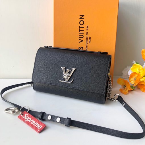 LOUIS VUITTON Lockme Clutch. Original Quality Bag including gift box, literature, dust bag, authenticity card. With its iconic LV turn lock and leather top handle for clutch carry, the Lockme Clutch is a striking day-to-evening bag. It boasts a clever strap with press studs to easily adjust the length for shoulder or cross-body carry. The small chain at the end of the strap brings a precious touch for evening occasions.