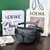 LOEWE Mini Gate Dual Bag. Discover the Art of Leather: Elevate your Style.  Exquisitely designed with utmost precision, the Mini Gate Dual showcases LOEWE's unparalleled expertise in leatherwork, enveloped in supple calfskin. Its distinctive features include a meticulously saddle-stitched knotted leather strap and a side-latched metal pin, from which the bag derives its name. Moreover, this miniature rendition is equipped with a removable shoulder strap, also rendered in calfskin, embellished with a repeated LOEWE pattern crafted in jacquard.