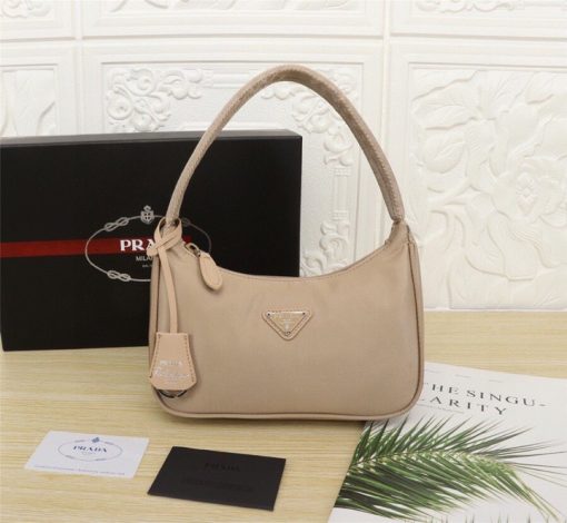 PRADA Re-Edition 2000 Nylon Mini Hobo. High-End Bag including gift box, dust bag, literature, and authenticity card. Practical and feminine, the nylon mini bag is decorated with iconic Saffiano leather trim. It features a contemporary mix of materials.