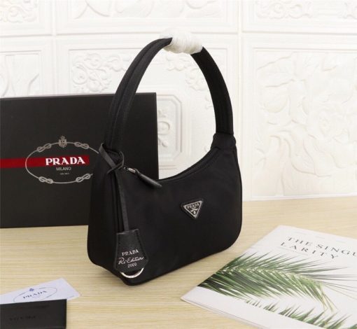 PRADA Re-Edition 2000 Nylon Mini Hobo. High-End Bag including gift box, dust bag, literature, and authenticity card. Practical and feminine, the nylon mini bag is decorated with iconic Saffiano leather trim. It features a contemporary mix of materials.