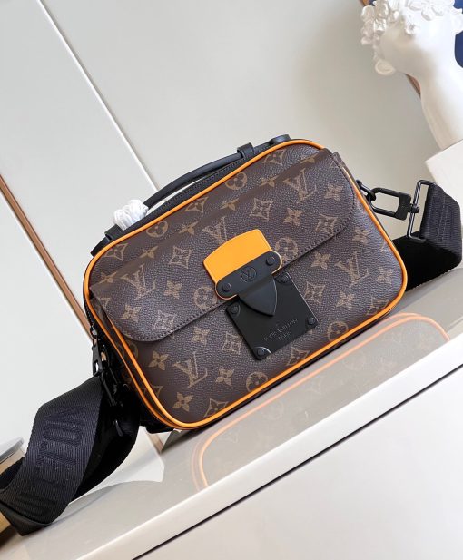 LOUIS VUITTON S Lock Messenger: A Fusion of Timeless Elegance and Modern Style. The S Lock Messenger in Monogram Macassar canvas showcases a unique closure, drawing inspiration from a trunk lock crafted by Georges Vuitton back in 1886. A meticulous finishing technique imparts the magnetic metal clasp with a strikingly contemporary appearance. Moreover, this avant-garde bag boasts a spacious zipped compartment, reminiscent of classic trunks, along with a luxurious leather handle and an iconic LV signature strap. Together, these features render it a fashionable and convenient accessory.