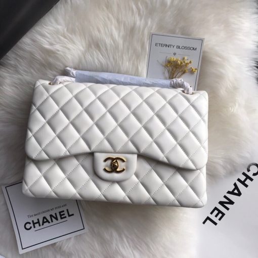 CHANEL 2.55 Classic Diamond Quilted Leather Double Flap Bag. Original Quality Bag. Authentic calfskin. Metal Toned Hardware. CHANEL Sales Box and Dust Bag. Booklet, Authenticity Card. The name 2.55 refers to the release of the bag in February 1955. It had a rectangular turn-lock which was called the Mademoiselle Lock. The 'CC' lock was introduced to the Classic Flap Bags only in the 1980s by designer Karl Lagerfeld. The all chain strap was replaced with the iconic leather interwoven chain link strap.