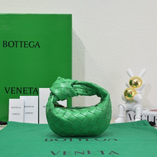 BOTTEGA VENETA Mini Jodie. Mini Marvel: Elevate Your Essentials. Introducing the BV Mini Jodie by Daniel Lee, a captivating embodiment of the mini bag trend infused with a captivating minimalist essence. True to the distinctive allure of the Jodie collection, this rendition showcases the iconic Intrecciato weave and the signature knot embellishment. Delicately compact, it effortlessly nestles under your arm akin to a charming baguette bag, yet offers ample space for your essentials such as your phone, cards, and keys. Despite its diminutive size, this mini bag radiates a vibrant aura through an array of lively hues, ensuring it leaves a memorable impression.