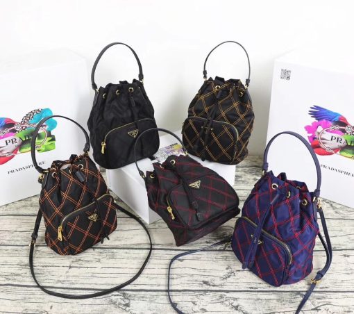 PRADA Quilted Bucket Bag. Original Quality Bag including gift box, care book, dust bag, authenticity card. PRADA nylon bucket bag with tessuto-impunturato quilted topstitching. Leather top handle. Drawstring top. Detachable Shoulder Strap. Front Zip Pocket with logo plate.