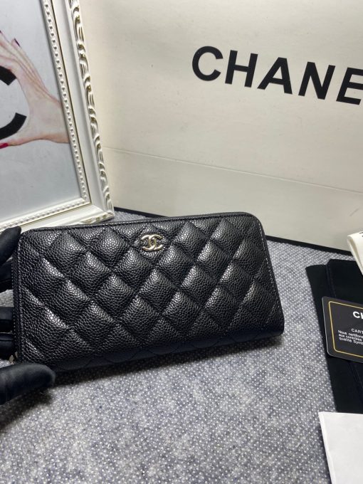 CHANEL Classic Long Zipped Wallet.  Original Quality Wallet including gift box, care book, dust bag, authenticity card. This wallet is one of the signature wallets of Chanel. It has been around for some time now and it will continue to stick around. This wallet is practical and amazing; perfect to hold paper money, credit cards and coins. The classic black color, you will get the signature burgundy colored interior. 