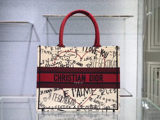 DIOR Book Tote. Original Quality Bag including gift box, care book, dust bag, authenticity card. This Book Tote is an original style introduced by Creative Director Maria Grazia Chiuri. This has become a staple of the Dior aesthetic. Ideally designed to carry all your daily essentials, the small shape is fully embroidered and the 'Christian Dior' signature on the front. This carryall is a perfect example of the Dior savoir-faire and also may be coordinated with a pouch or other small leather goods for a complete look.