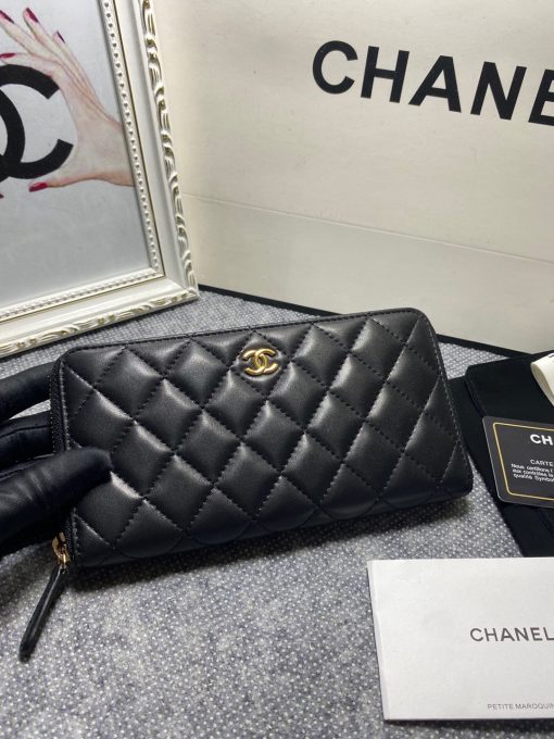 CHANEL Classic Long Zipped Wallet.  Original Quality Wallet including gift box, care book, dust bag, authenticity card. This wallet is one of the signature wallets of Chanel. It has been around for some time now and it will continue to stick around. This wallet is practical and amazing; perfect to hold paper money, credit cards and coins. The classic black color, you will get the signature burgundy colored interior. 