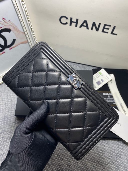 CHANEL 'Boy' Long Zipped Wallet. Original Quality Wallet with literature, dust bag, box and authenticity card. The Chanel 'Boy' Wallets have always been as popular as the Boy Chanel Quilted Bags. Everything about the design resemble to the Boy Bag line including the quilting with stripes on the edges and the boy clasp as well. The calfskin/lambskin makes sure that you don’t need to constantly babying it and it will not get damaged so easily if it sits next to your keys, inside your bag. This wallet is practical and amazing; perfect to hold paper money, credit cards and coins.