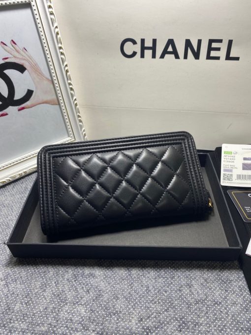 CHANEL 'Boy' Long Zipped Wallet. Original Quality Wallet with literature, dust bag, box and authenticity card. The Chanel 'Boy' Wallets have always been as popular as the Boy Chanel Quilted Bags. Everything about the design resemble to the Boy Bag line including the quilting with stripes on the edges and the boy clasp as well. The calfskin/lambskin makes sure that you don’t need to constantly babying it and it will not get damaged so easily if it sits next to your keys, inside your bag. This wallet is practical and amazing; perfect to hold paper money, credit cards and coins.